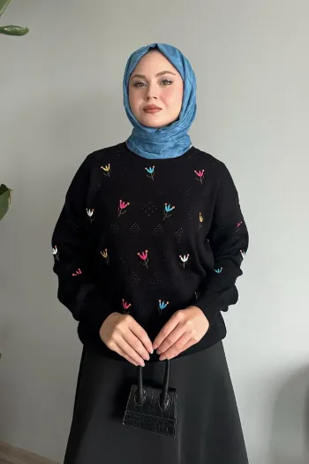 Black knitted sweater featuring an intricate rose pattern