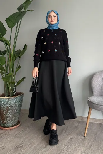 Black knitted sweater featuring an intricate rose pattern