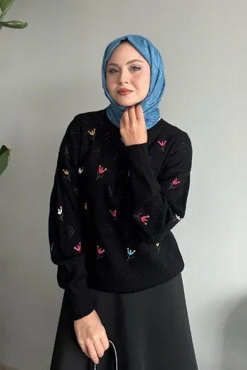 Black knitted sweater featuring an intricate rose pattern